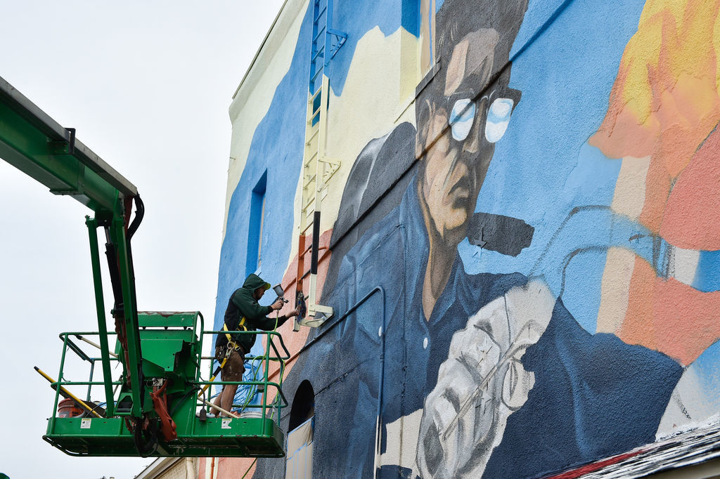 Local artist Dan Black paints his mural called "Band on the Run", near the intersection of North Locust Street and East Oak Street.Black described the mural as being music themed that showcases 1940s and 1950s motorcycle culture. It should be finished a
